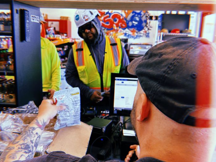 Customers at the checkout counter inside Fifty's Market & Liquor