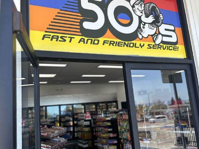 Front entrance of Fifty's Market & Liquor with the 50's Fast and Friendly Service sign