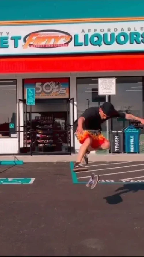 Skateboarder catching air in front of Fifty's Market & Liquor