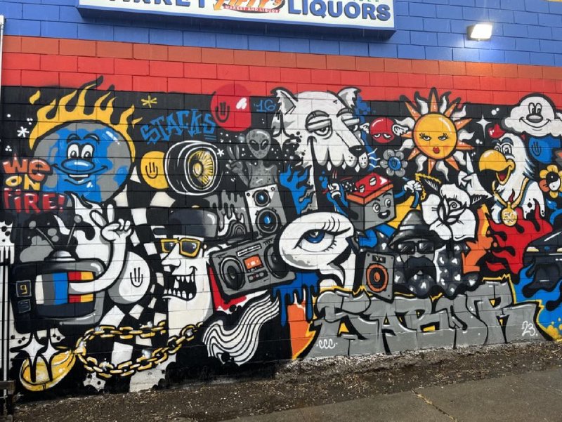 Graffiti mural on the side wall of Fifty's Market & Liquor
