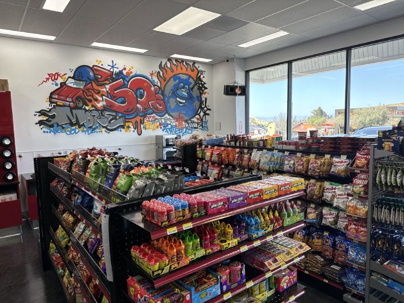Snack and candy aisles inside Fifty's with the 50's graffiti mural